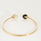CARTIER - Amulette - Bracelet jonc ouvert en or rose, onyx, nacre et diamants