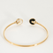CARTIER - Amulette - Bracelet jonc ouvert en or rose, onyx, nacre et diamants