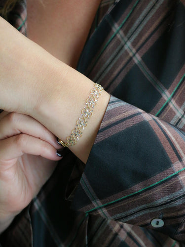 Bracelet Bracelet dentelle trèfle en or jaune et or blanc 18 carats 58 Facettes 1CA0000052/1