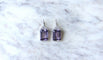 https://cdn.shopify.com/s/files/1/0075/4588/0666/files/boucles-doreilles-style-art-deco-amethyste-et-diamant-605260.jpg?v=1740553073