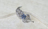 https://cdn.shopify.com/s/files/1/0075/4588/0666/files/broche-clip-Boucheron-saphirs-et-diamants-456440.jpg?v=1739836428