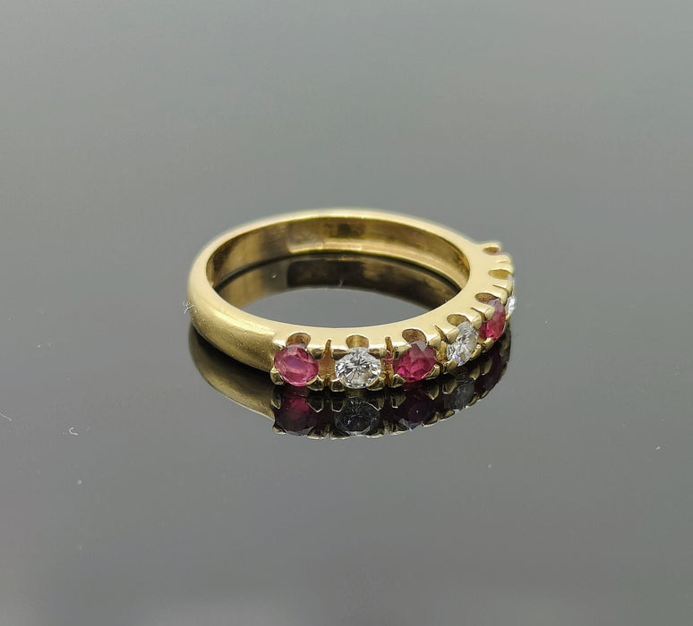 Half wedding ring adorned with rubies and diamonds