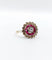 Bague 48 Bague fleur art deco or rose 18k ornée d'un diamant taille brillant entouré de rubis calibrés dans une monture finement travaillée (circa 1920) 58 Facettes A04432