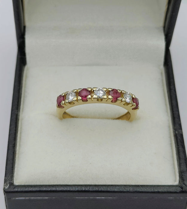 Half wedding ring adorned with rubies and diamonds