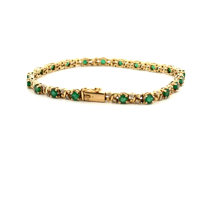 Rivière bracelet in yellow gold, diamonds and emeralds