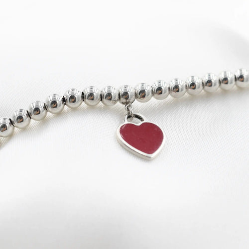 Bracelet Tiffany & Co. - Bracelet en argent sterling avec breloque cœur rouge. Veuillez retourner à Tiffany. 58 Facettes