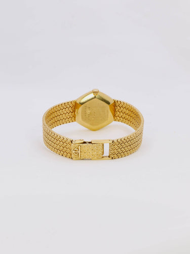 Montre BAUME & MERCIER Montre vintage or jaune maille tressée 58 Facettes 1067.3