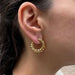 Boucles d'oreilles CARTIER - Boucles d’oreilles créoles en or jaune 58 Facettes