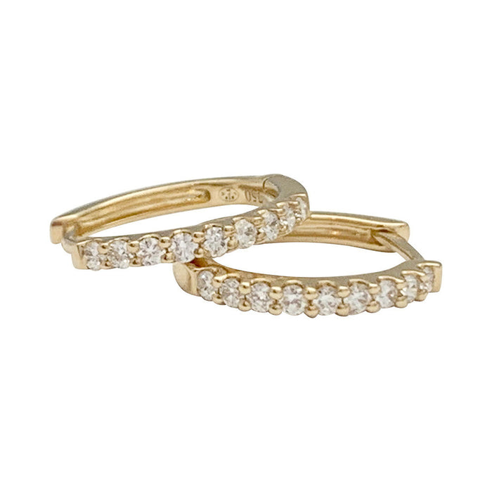 Pair of small yellow gold hoop earrings with diamonds.