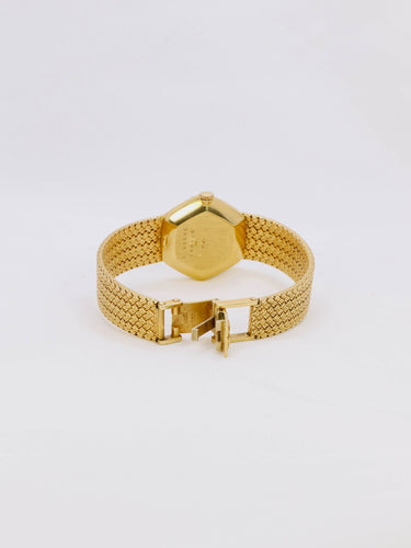 Montre BAUME & MERCIER Montre vintage or jaune maille tressée 58 Facettes 1067.3