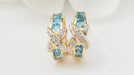 Boucles d'oreilles Boucles d'oreilles créoles en or blanc,Topaze bleue et diamants 58 Facettes 28590