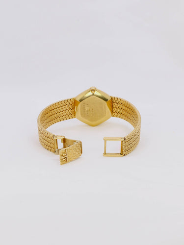 Montre BAUME & MERCIER Montre vintage or jaune maille tressée 58 Facettes 1067.3