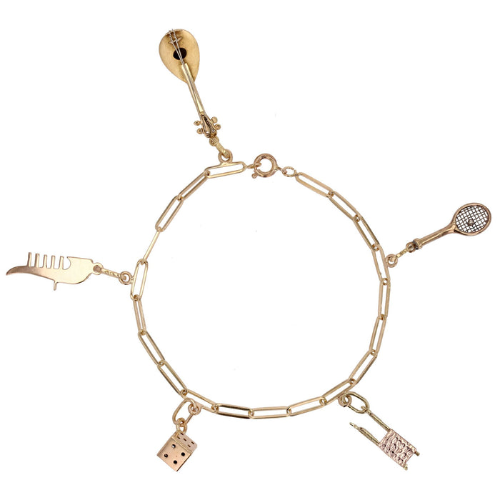 Yellow gold curb bracelet and its charms