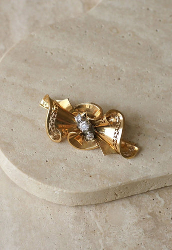 Broche Broche noeud or rose, platine et diamants 58 Facettes