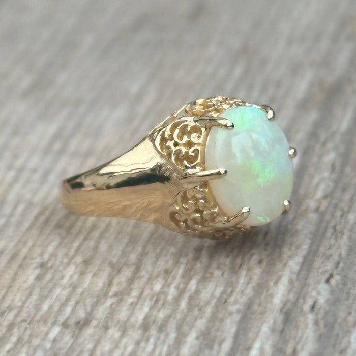 Old openwork ring set with a cabochon opal