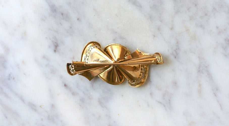 Broche Broche noeud or rose, platine et diamants 58 Facettes