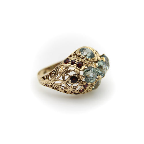 Bague Bague bombée en or avec topaze bleue victorienne et grenat 58 Facettes A20050