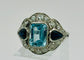 Bague 54 Bague Art Déco en platine ornée d'aigues-marines, de saphirs et de diamants 58 Facettes 50308