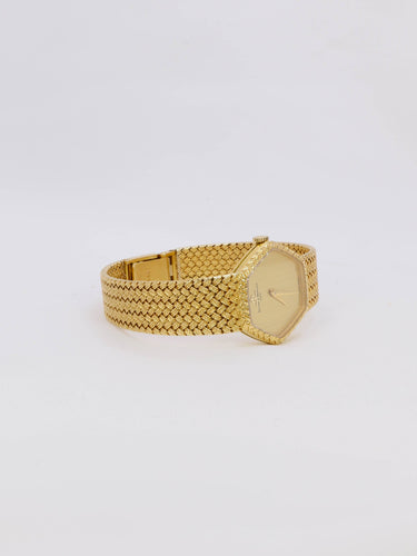 Montre BAUME & MERCIER Montre vintage or jaune maille tressée 58 Facettes 1067.3