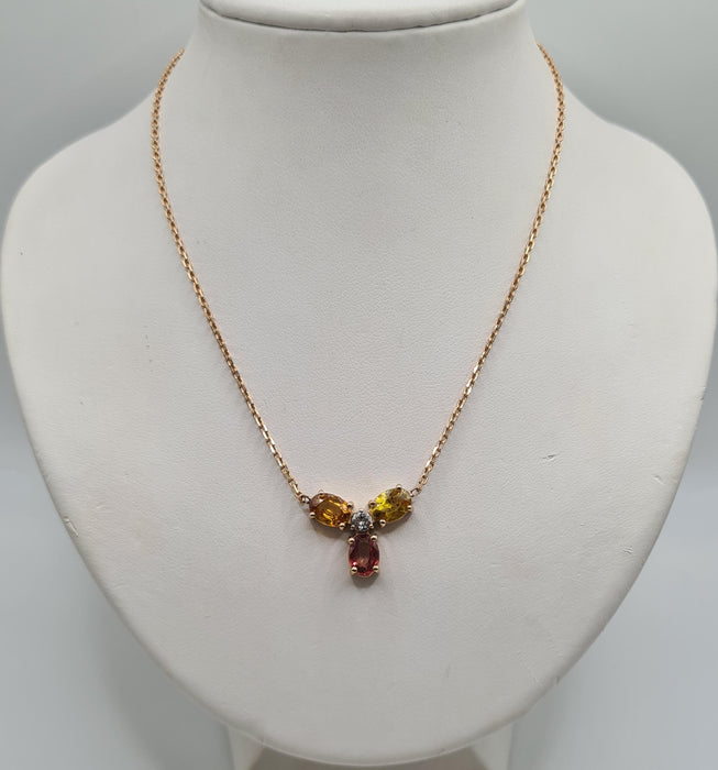 Rose gold necklace set with sapphires and a diamond
