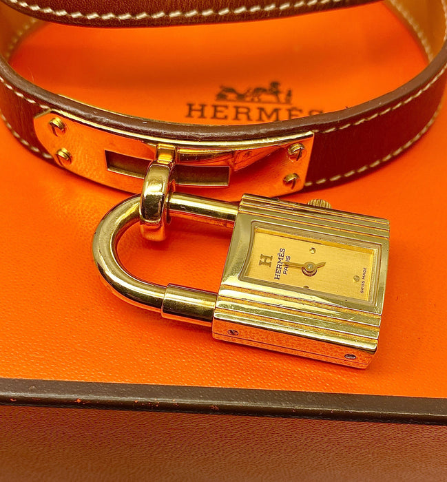 Montre Hermès  - Montre «  Kelly », cadran PM plaqué or, double tour cuir marron 58 Facettes AB453