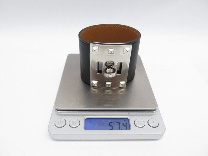 Bracelet bracelet HERMES extreme kelly dog manchette en cuir noir 50mm 58 Facettes 267199