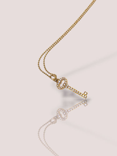 Halskjedeholderclés Tiffany & Co i 18 karat gult gull med diamanter