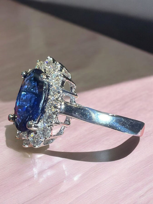 white gold sapphire ring surrounded by diamonds