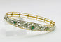 Bracelet Bracelet en or jaune orné de motifs floraux en argent, émeraudes et diamants 58 Facettes 50319
