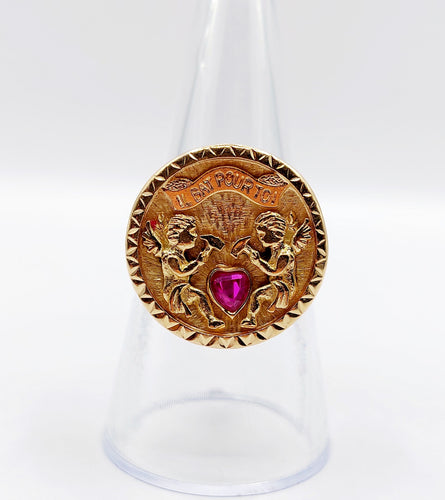 Bague 55 Bague vintage "il bat pour toi" or rose, angelots sculptant un coeur en rubis synthétique 58 Facettes A05267