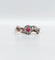 Bague 55 Bague marguerite antique or rose, rubis et diamants (c.1890) 58 Facettes A05453