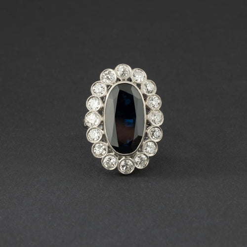 Bague Bague marguerite en platine, saphir et diamants. 58 Facettes