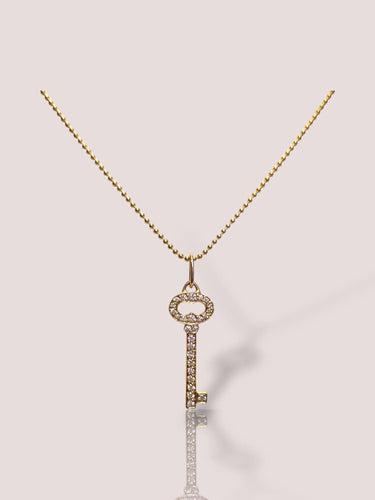 Halskjedeholderclés Tiffany & Co i 18 karat gult gull med diamanter