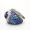 Bague 56 Bague or gris, tanzanite, entourage diamants et saphirs 58 Facettes