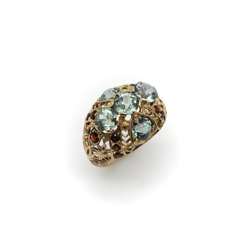 Bague Bague bombée en or avec topaze bleue victorienne et grenat 58 Facettes A20050