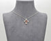 Collier Collier croix en or blanc avec rubis et diamants 58 Facettes 10430