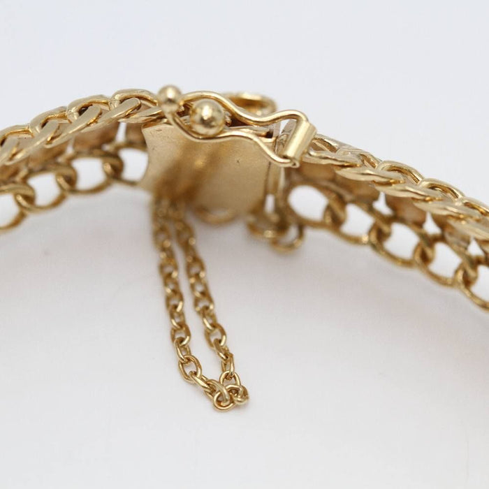 Pulsera articulada con medalla de oro de 18k.