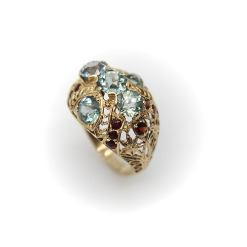 Bague Bague bombée en or avec topaze bleue victorienne et grenat 58 Facettes A20050