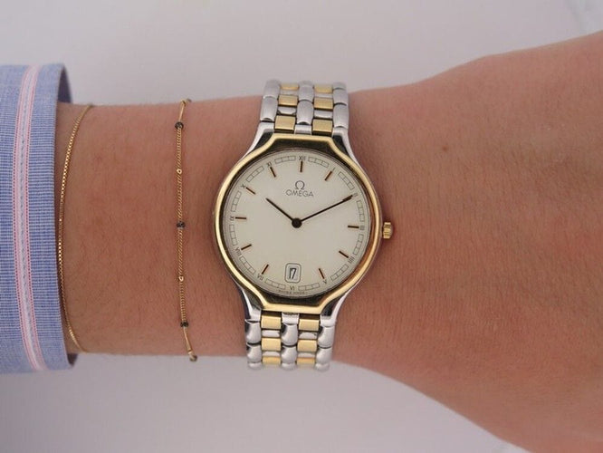 Montre vintage montre OMEGA deville symbol quartz en or et acier 58 Facettes 260174