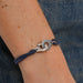 Bracelet DINH VAN - Bracelet Menottes en argent et cordon bleu 58 Facettes 98251