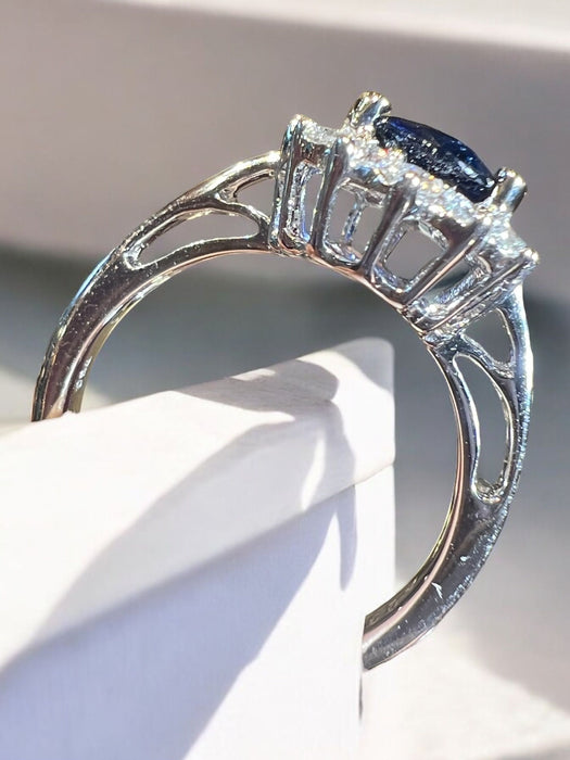 white gold sapphire ring surrounded by diamonds