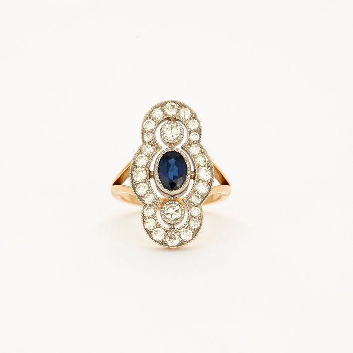 Art Deco Style ring in yellow gold, platinum, diamonds and sapphire center.