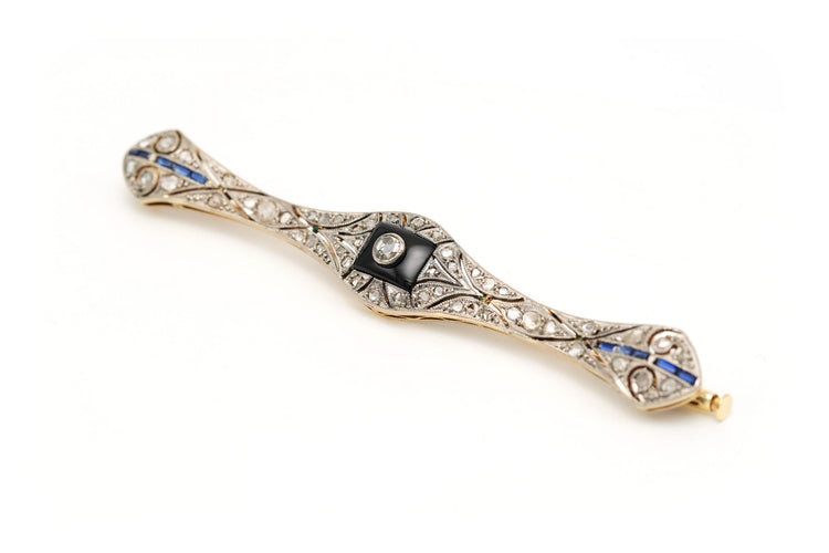 Broche Broche Art Déco sertie d’onyx, saphirs et diamants en or jaune et blanc 18 carats 58 Facettes 23114