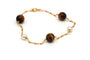 Bracelet Bracelet contemporain en or jaune, perles et œil de tigre 58 Facettes 13428