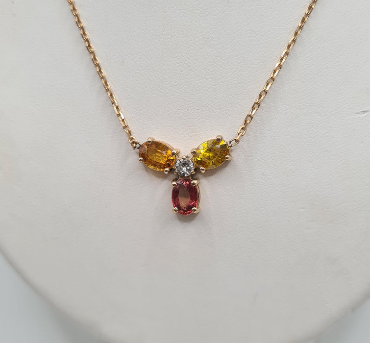 Rose gold necklace set with sapphires and a diamond