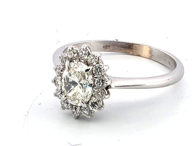 Bague 54 Bague en or blanc avec un diamant ovale au centre et des diamants brillants tout autour. 58 Facettes