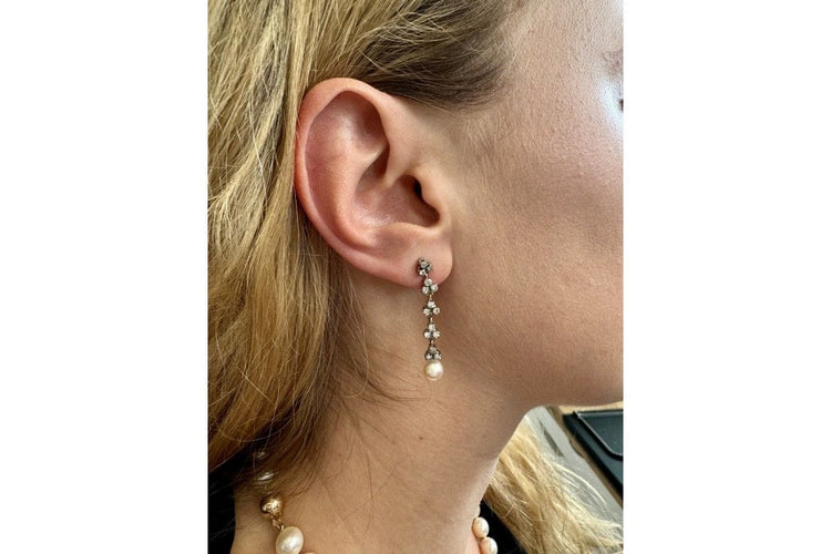 A unique pair of earrings with pearls and diamonds. 