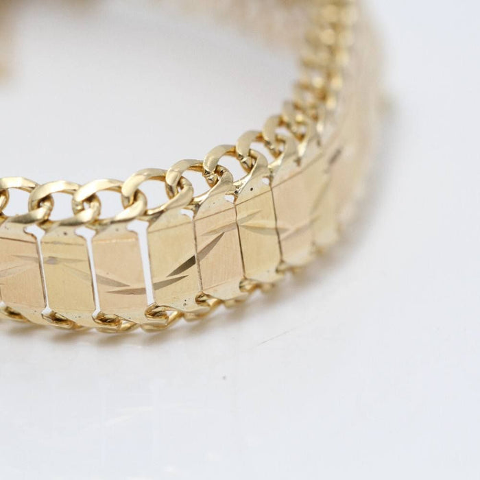 Articulated bracelet with 18k gold medal