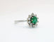 Ring Daisy in white gold adorned with an emerald and diamonds 