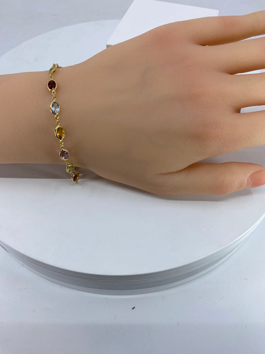 Armband aus Gelbgold und feinen Steinen